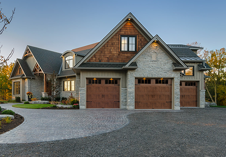 modern house with three wooden garage doors